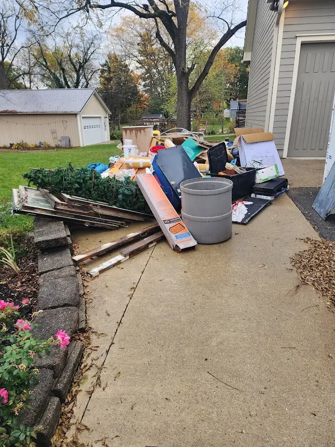 Dumpster being loaded with debris for 12 Yard Dumpster Rental in Rolla